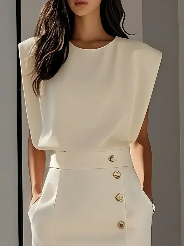  Model displaying a midi dress with a polished finish on a plain background.