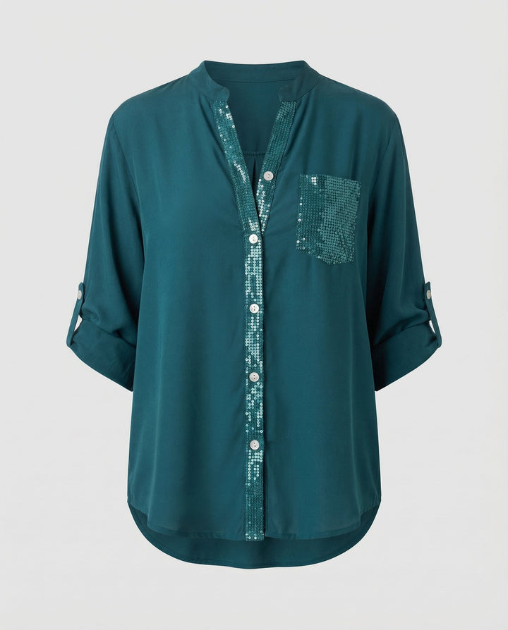 Female model showcasing a comfortable blouse with a glittering pocket feature.