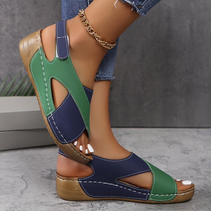 Female model wearing travel-ready sandals on a plain background