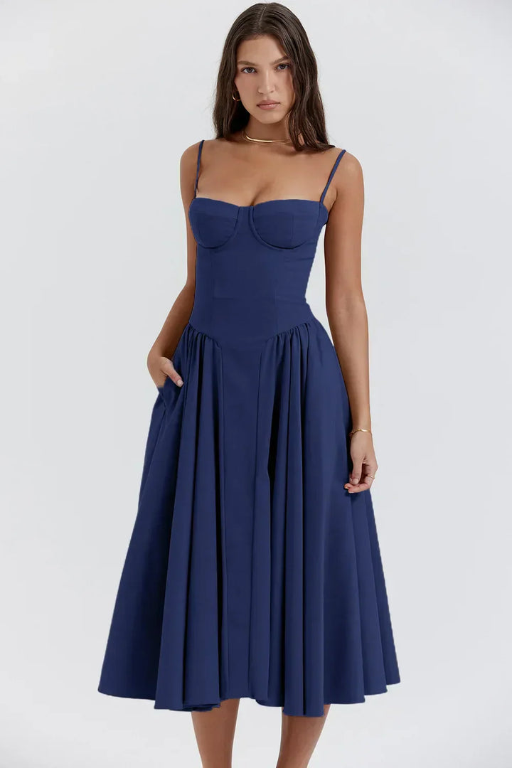 Female model in a lightweight summer midi dress on a plain background