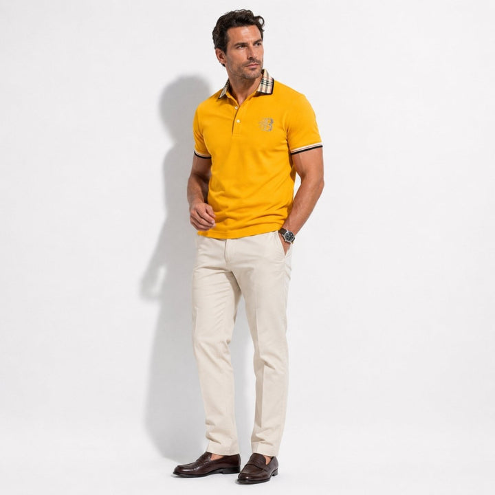  Model styled in a men’s short sleeve polo shirt with patterned trim on a plain background.