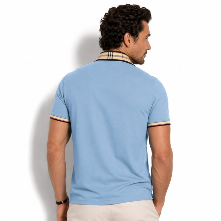  Model styled in a casual polo shirt with clean contrast accents on a plain background.