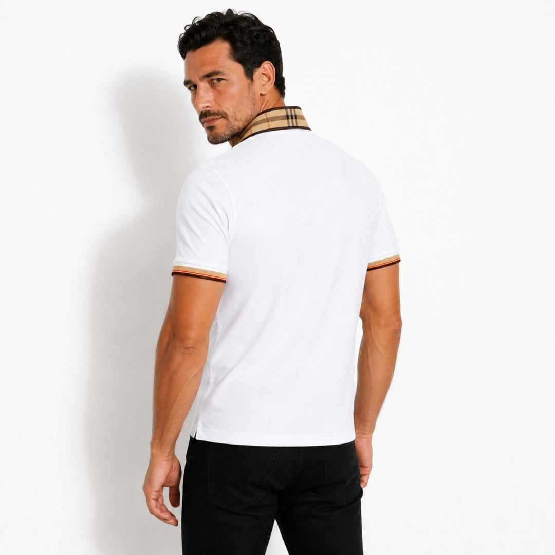  Model wearing a navy polo shirt designed for everyday styling on a plain background.