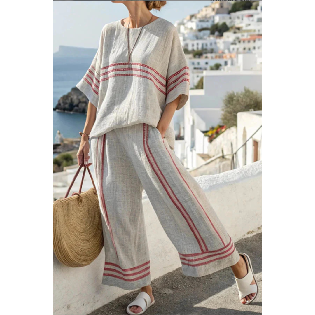 Woman showcasing a graceful coordinated outfit on a ocean background.