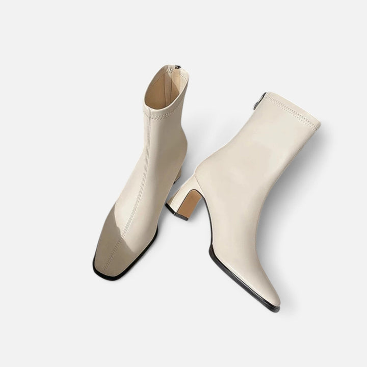 Stylish ankle boots suitable for day-to-night outfits on a plain background.