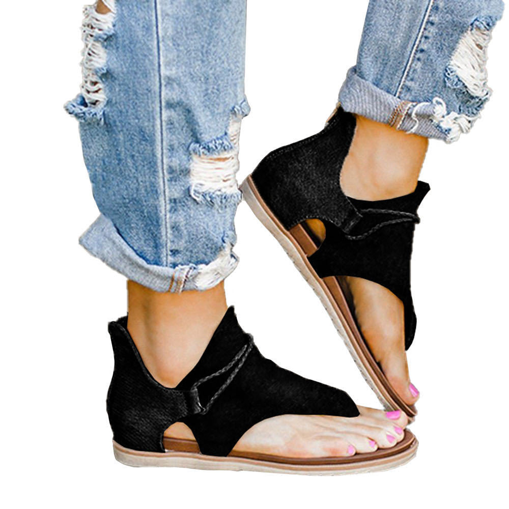 Foot model displaying elegant sandal shape on plain background.
