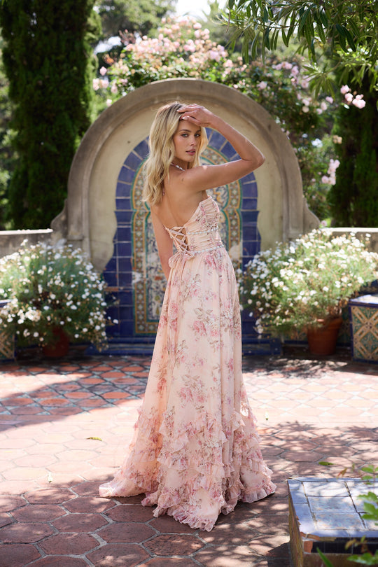 Peach-toned floral gown displayed on a plain background with lace-up back detail.