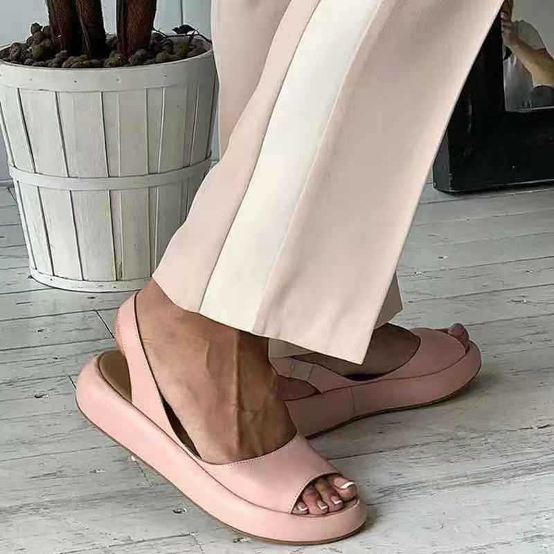 Side view of flat sandals on foot model white background