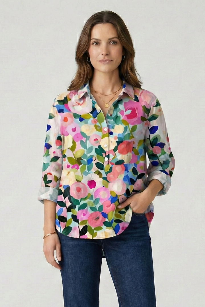 Multicolor collared floral blouse laid flat white surface