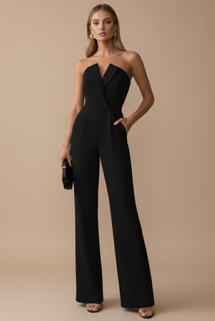 Model wearing strapless jumpsuit front view plain background standing pose