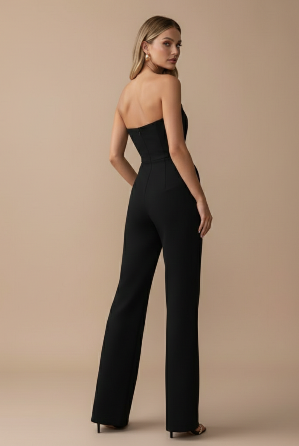 Back view of model wearing full length strapless jumpsuit plain