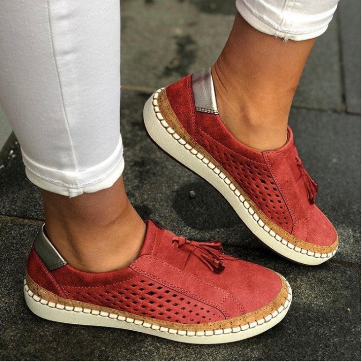 Woman standing in lightweight everyday slippers against a plain background.