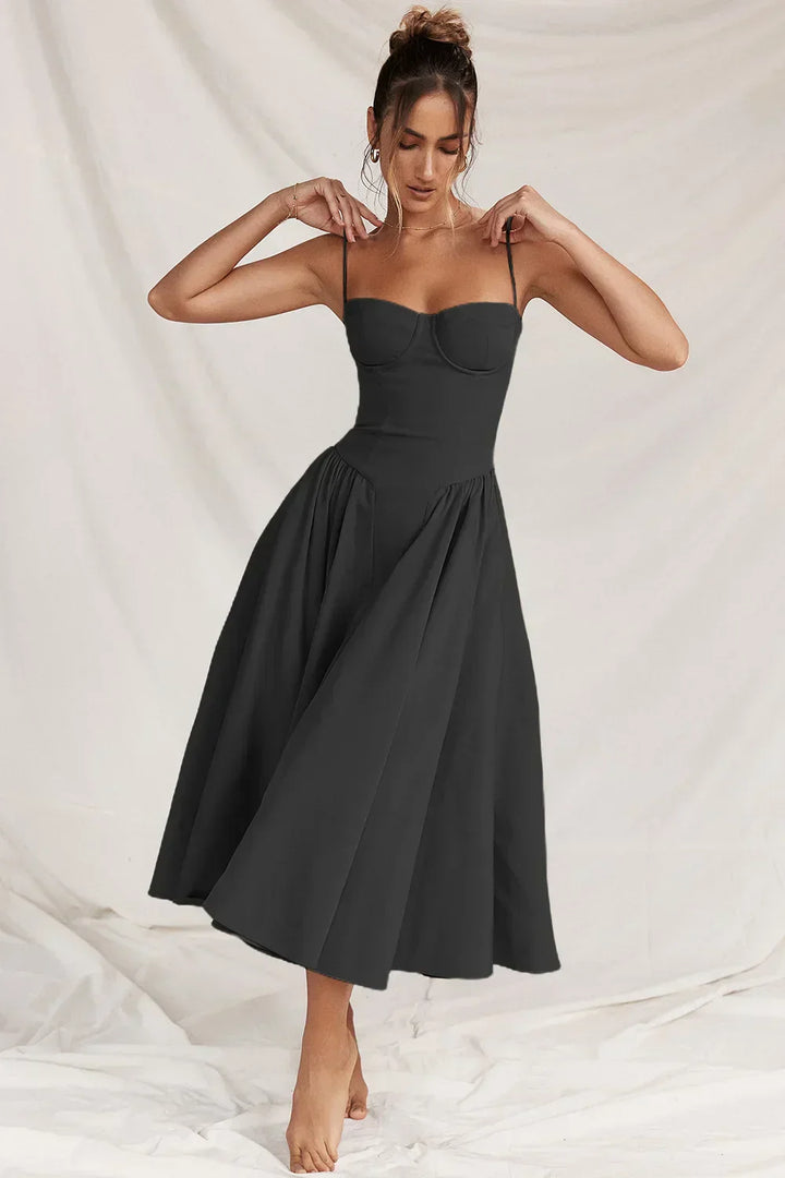 Female model posing in a relaxed fit summer dress on a plain background
Woman in a flowing
