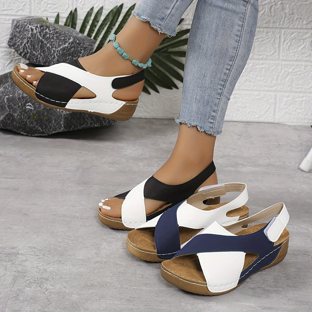 Female model wearing casual walking sandals on a plain background