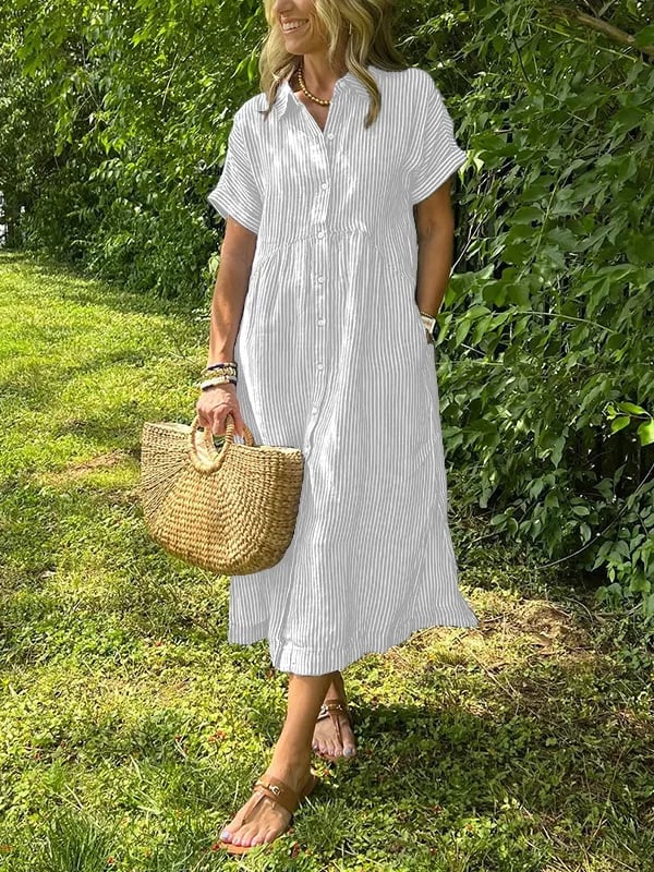 Female showcasing a striped button shirt with a relaxed fit on a plain background.