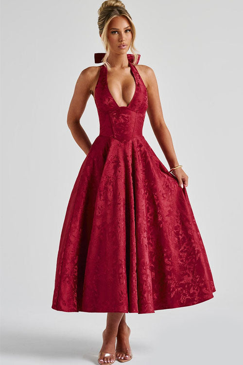 Sleeveless women’s occasion dress on a plain background.