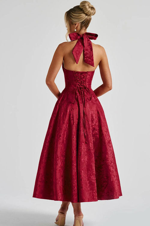 Flared halterneck dress with shaped waist detail.