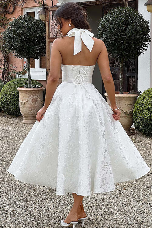 Halterneck event dress with a graceful flared silhouette.