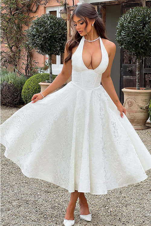Women’s sleeveless dress with textured skirt and fitted waist.