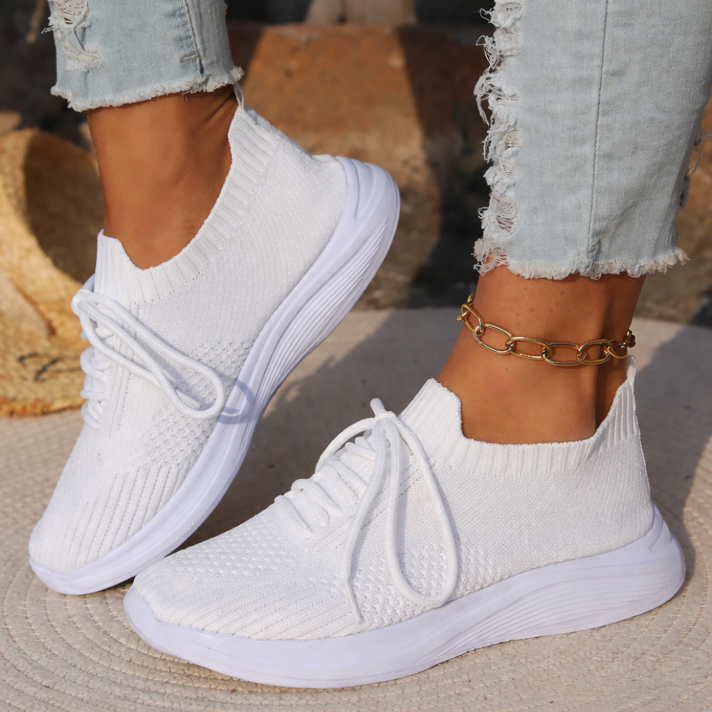 Stylish sneakers and gold anklet