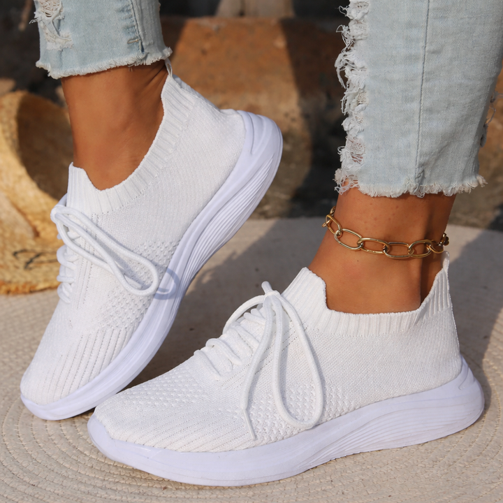 Stylish sneakers and gold anklet