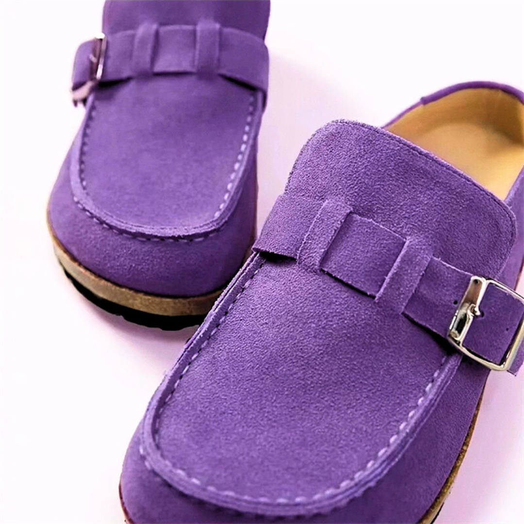 Purple loafers with buckles on a white background
