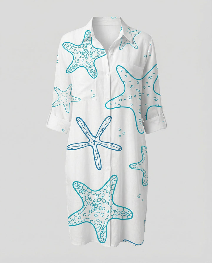 Female model showcasing a button-front beach shirt with a vibrant coastal design.