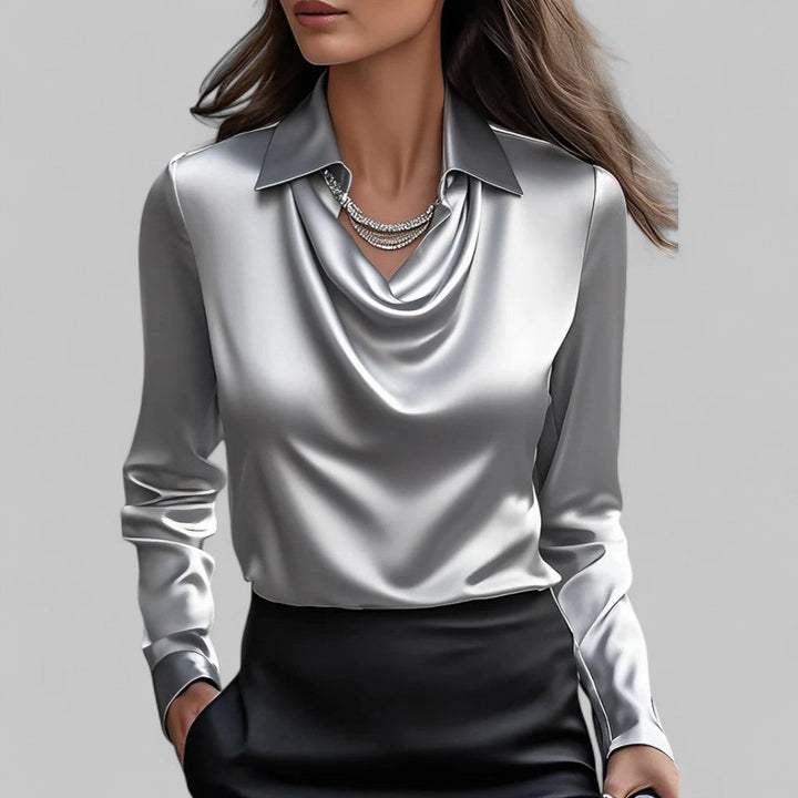 Elegant satin blouse worn by a woman model against a plain background.