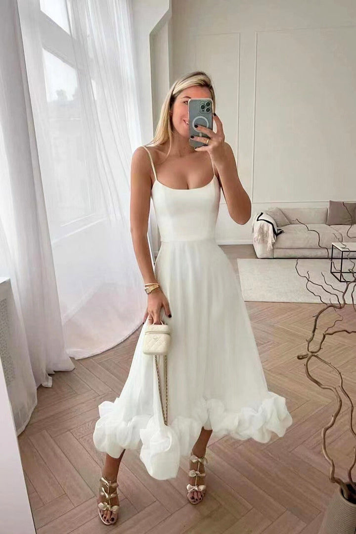 White occasion dress photographed with scenic background