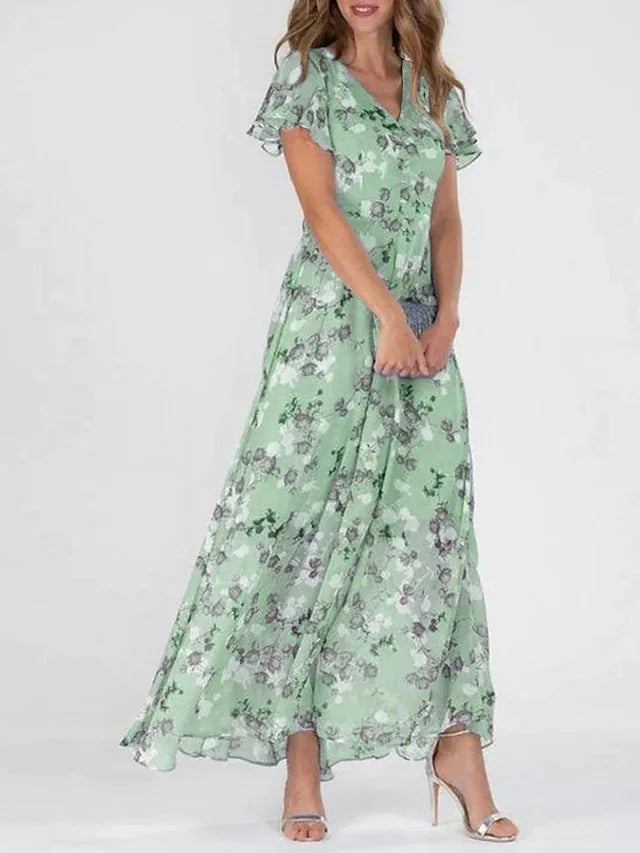 Woman modeling a stylish midi dress on a plain background.