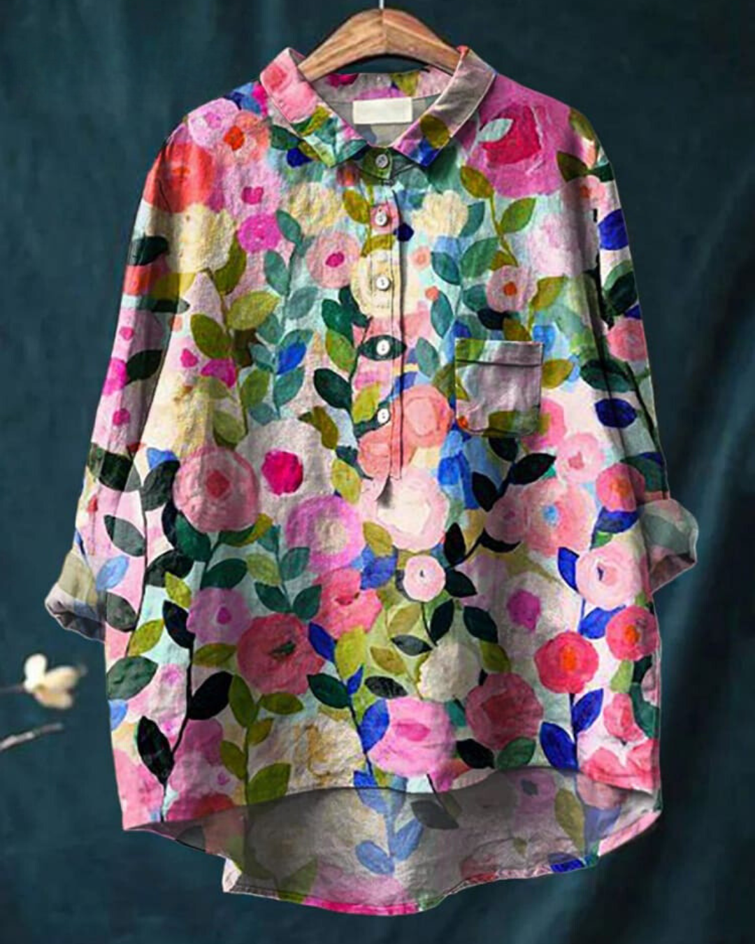Floral button front blouse on a plain background with colorful summer print.