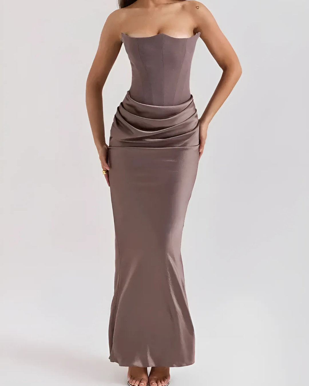 Model wearing flowing maxi dress front pose plain background