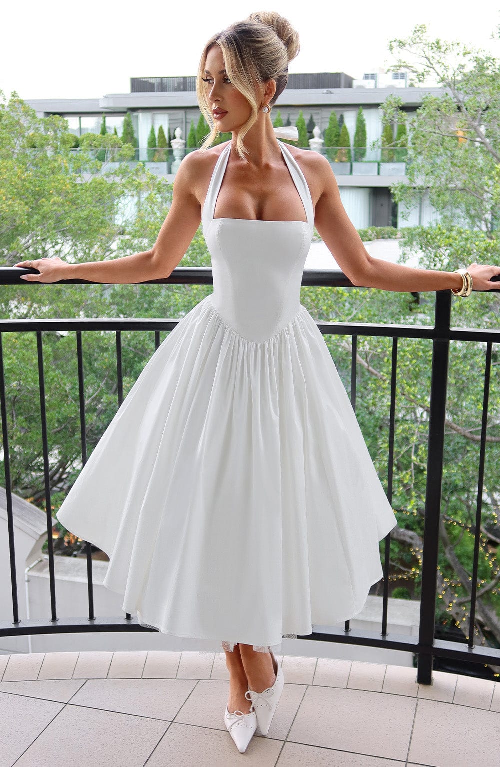 Woman wearing elegant halter midi dress on nature view background.