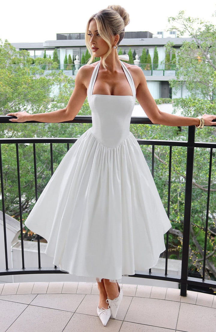 Woman wearing elegant halter midi dress on nature view background.