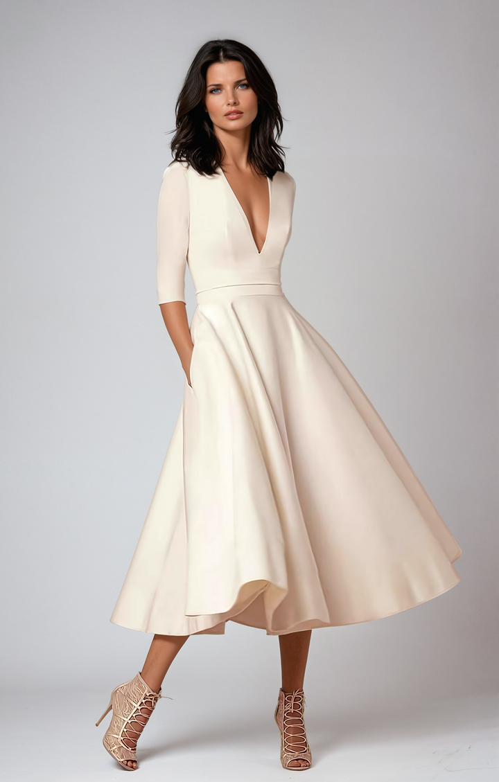 Woman wearing flared midi dress front view plain background