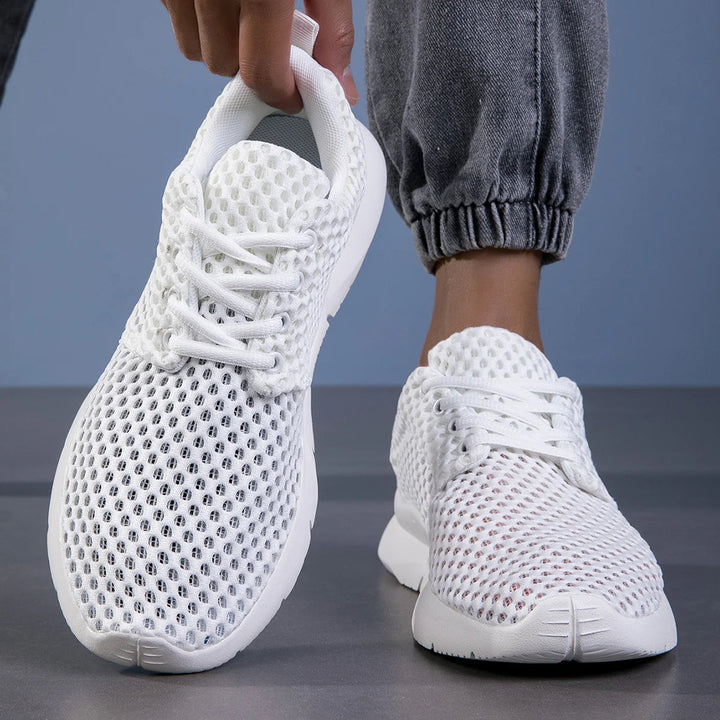 White lace-up shoes with sporty casual design close-up view