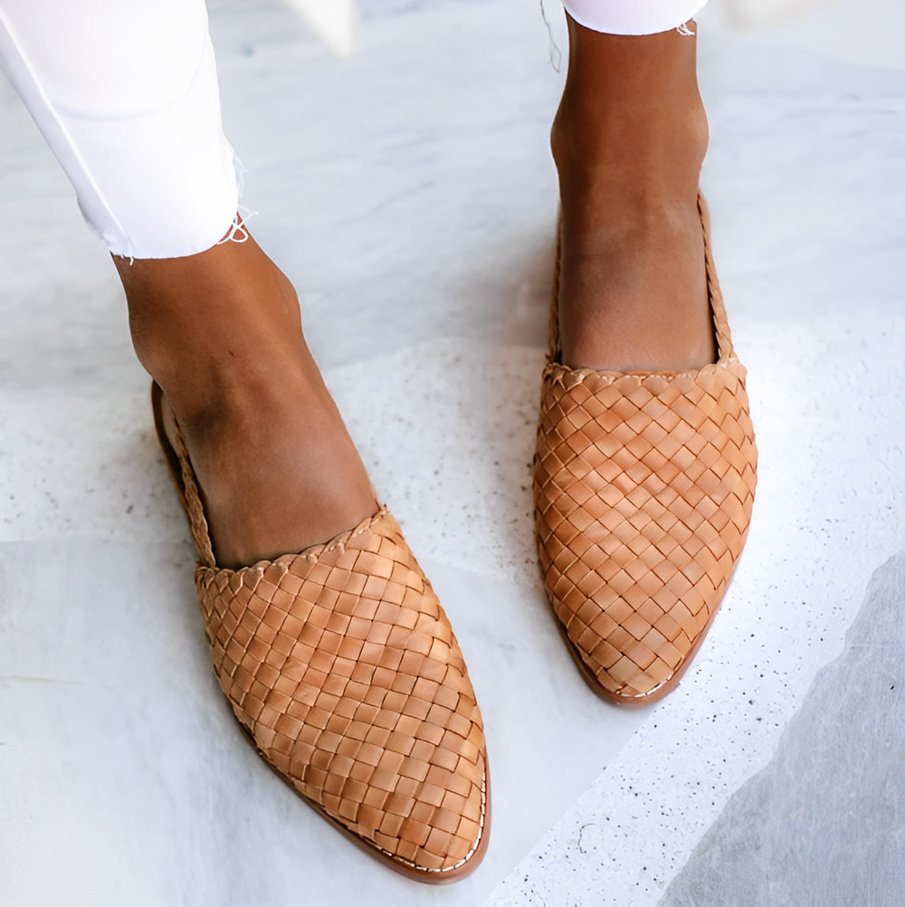 Front angle of structured women’s shoe on plain neutral background