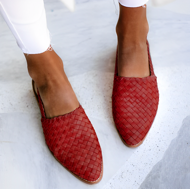 Angled view of polished women’s shoe on simple plain background