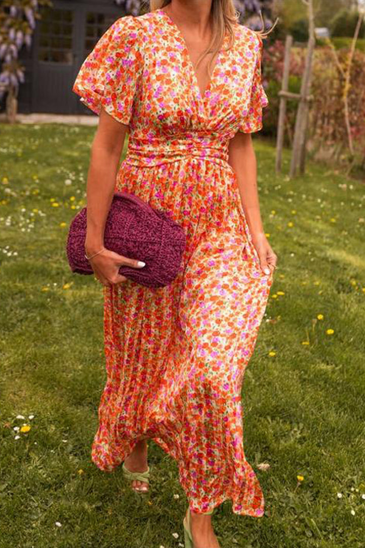 Outdoor front angle of vibrant floral maxi with textured clutch