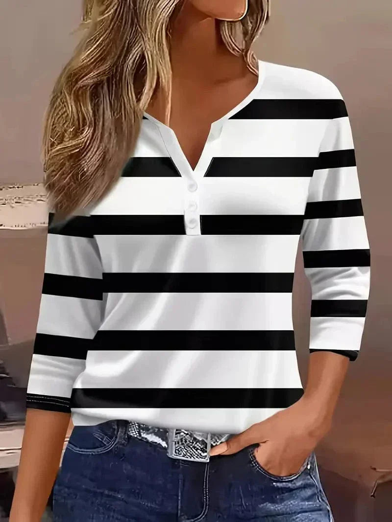 Woman showcasing a lightweight striped top with petal-style sleeves.