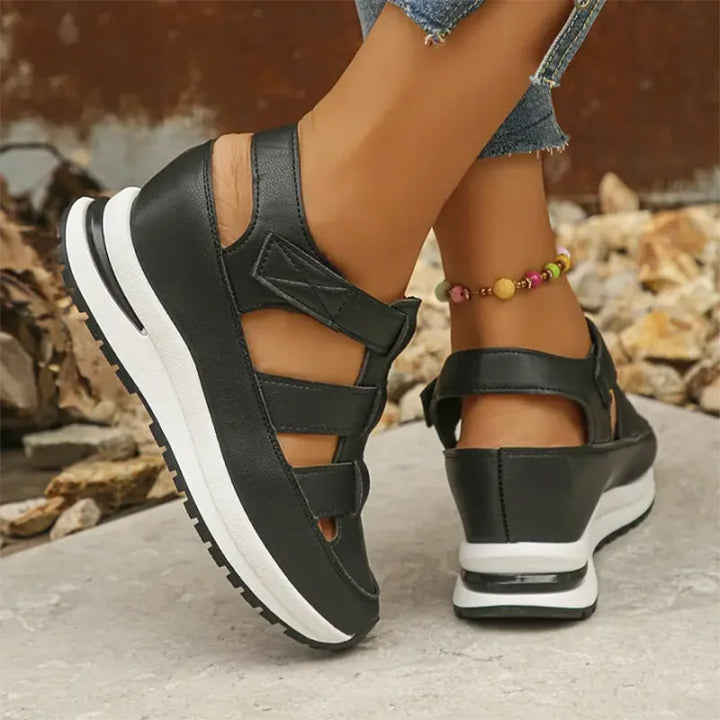 Strappy black platform sneakers with open side details