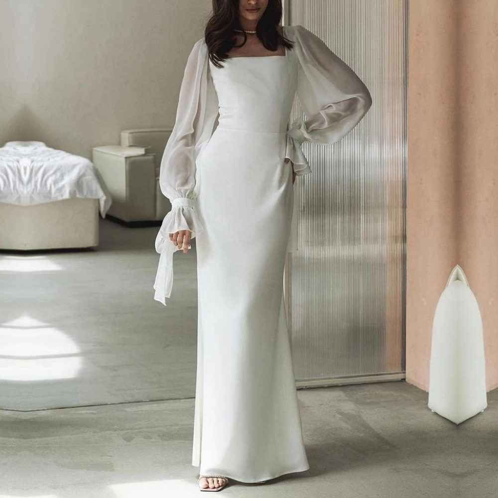 Model standing front view plain background showcasing long evening dress