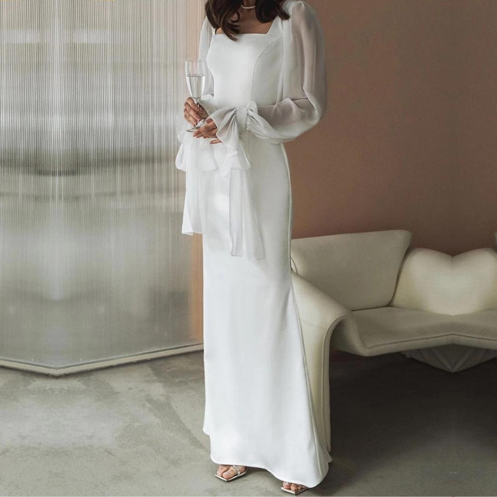 Model back view plain background showing full length elegant dress