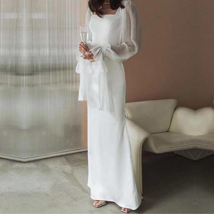 Model back view plain background showing full length elegant dress