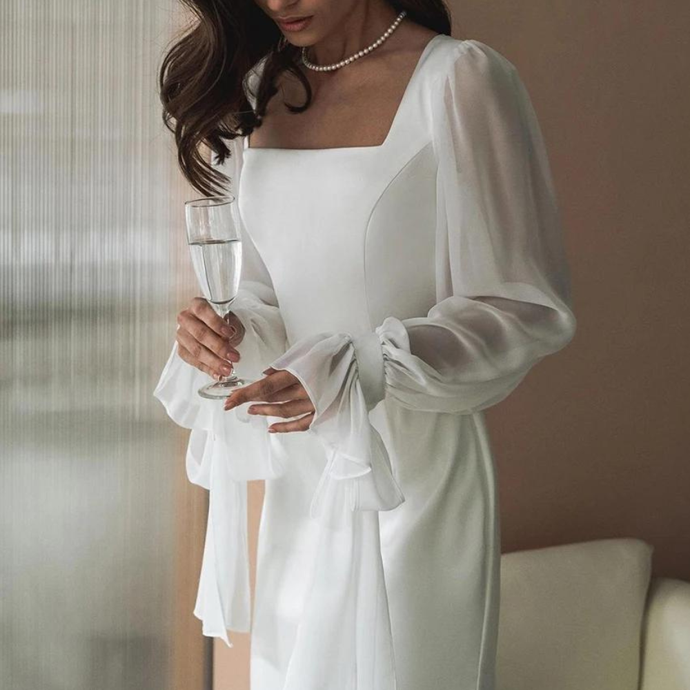 Model close front angle plain background emphasizing neckline and shoulders