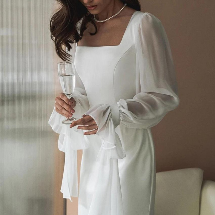 Model close front angle plain background emphasizing neckline and shoulders