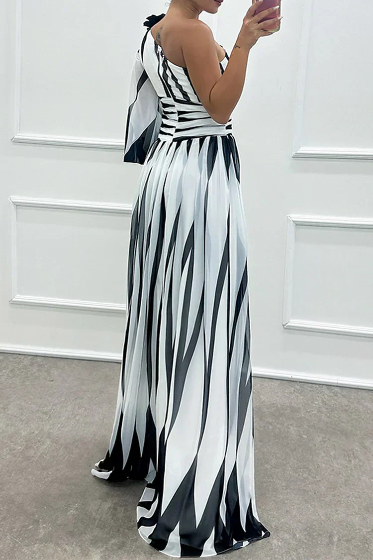 Female model showing a flowing striped dress against a plain background.