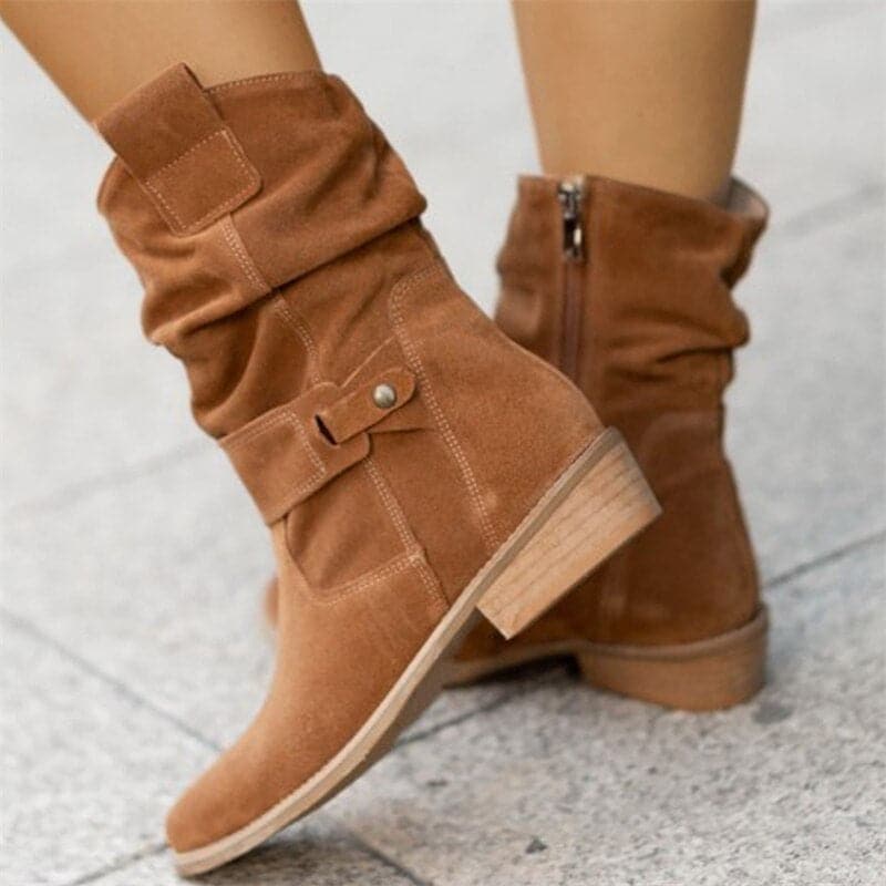 Brown boots with buckles on a light gray background