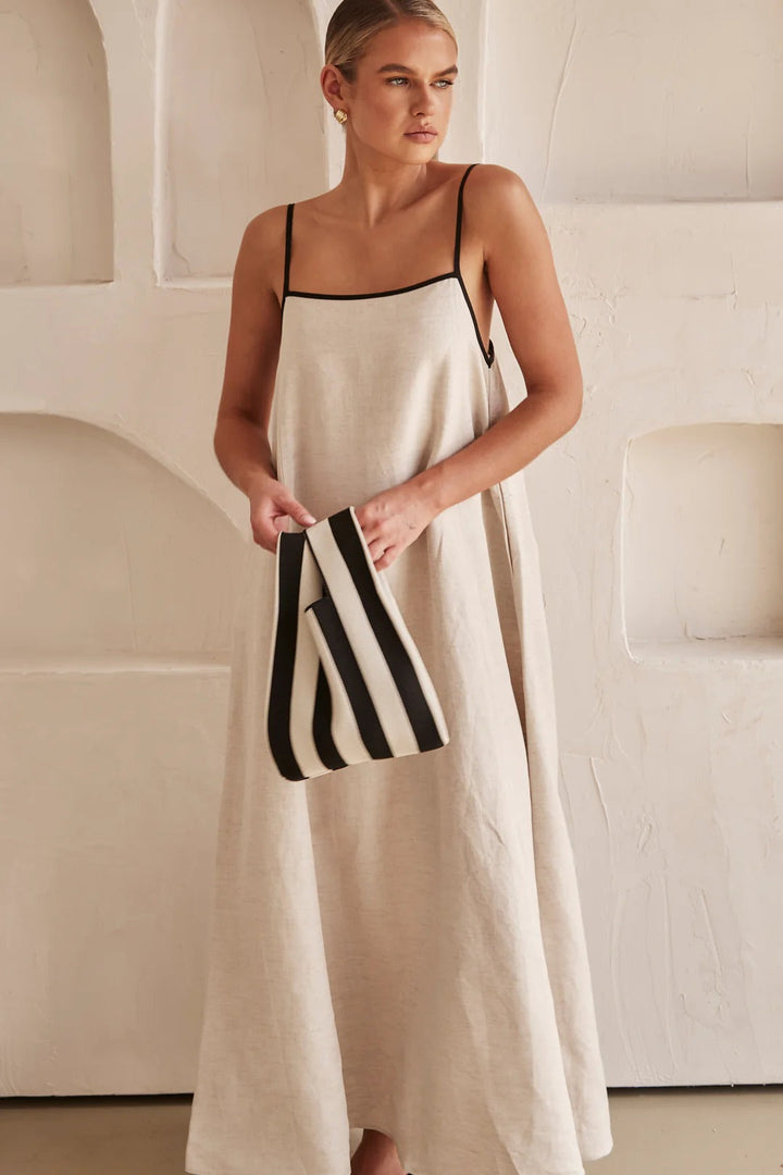 Female model turning slightly showing dress movement clean plain background