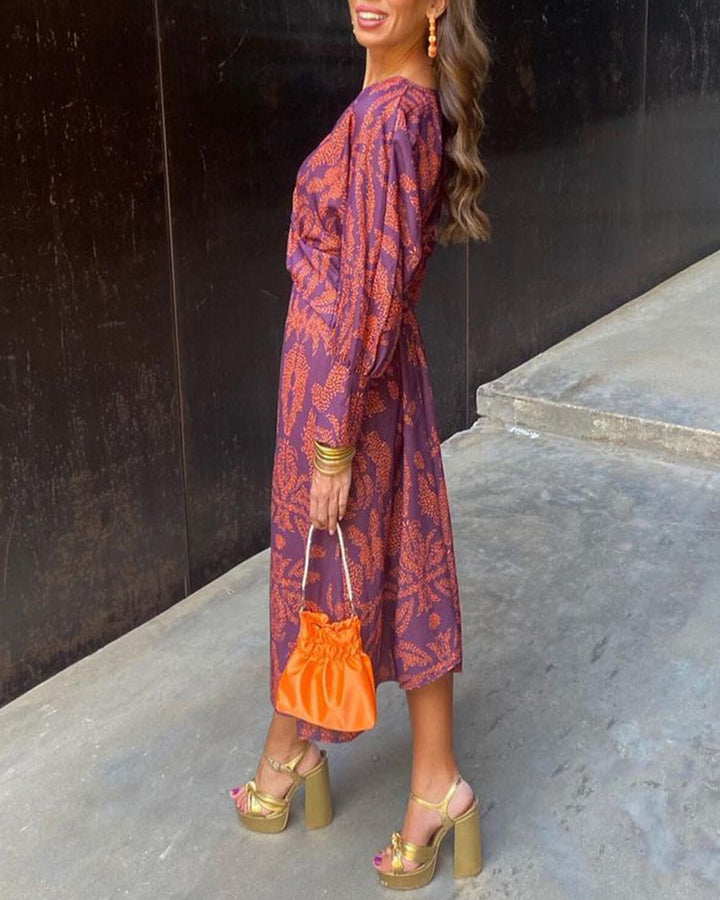 Woman wearing a printed A-line maxi dress suitable for wedding guest occasions.
